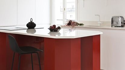 A kitchen with a red island