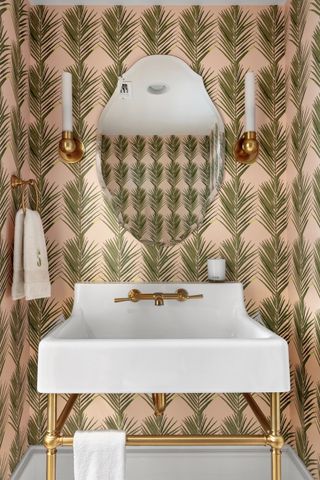 powder room with fern wallpaper, white basin, brass taps, mirror