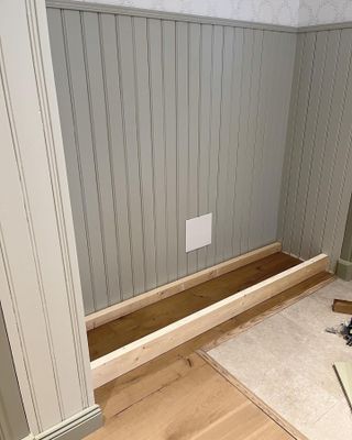 Storage seating in the process of being made in a panelled alcove