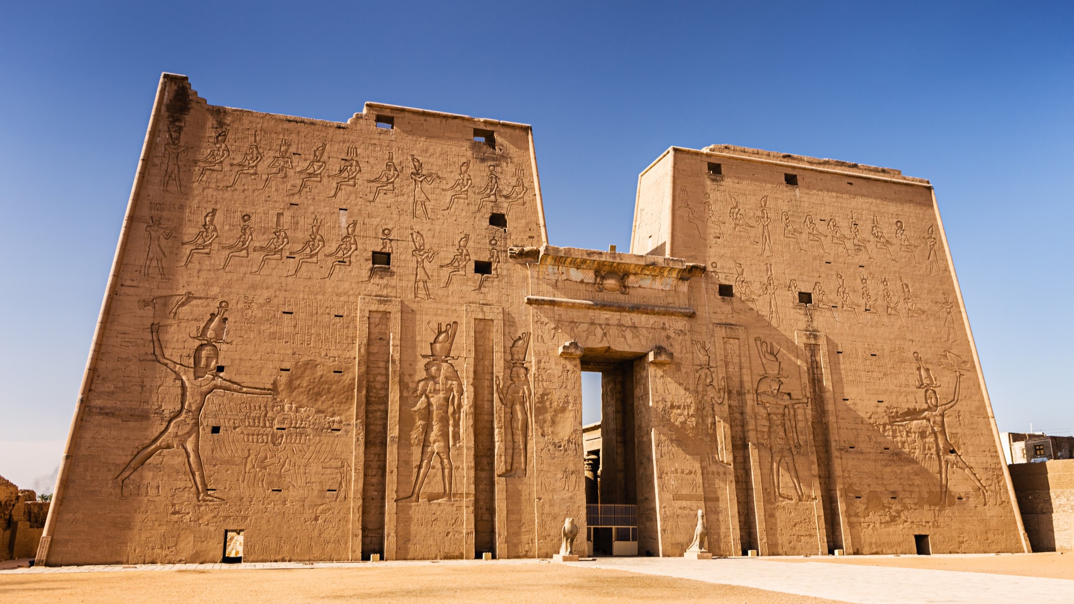 Edfu Temple of Horus is a large Ancient Egyptian temple complex located on West Bank of Nile River, between Esna and Aswan in Egypt. A large temple stands tall with large inscriptions on the walls.