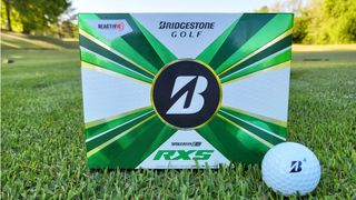 Bridgestone 2022 Tour B RXS Golf Ball with packaging on the ground