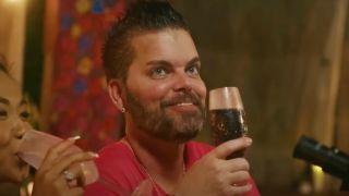 Tim Malcolm smiling and enjoying a drink