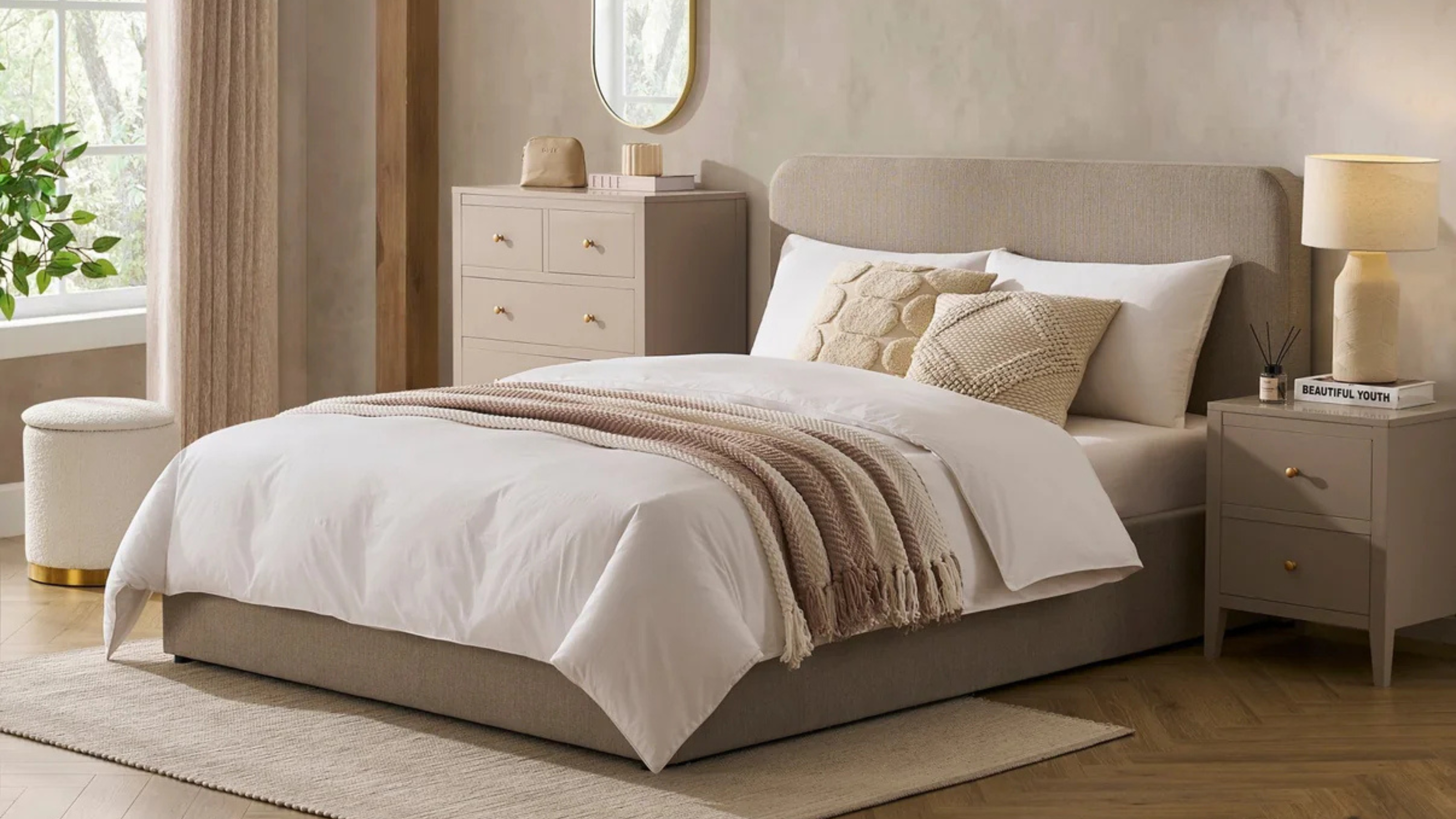 Dusk Ascot Ottoman Storage Bed in Stone Grey with neutral duvet, throw and cushions in a taupe bedroom.