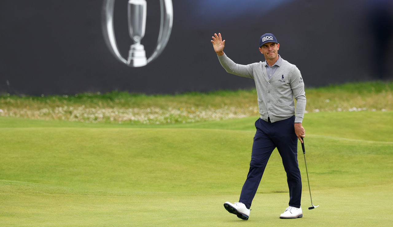 Billy Horschel waves to the crowd as he walks up the 18th fairway