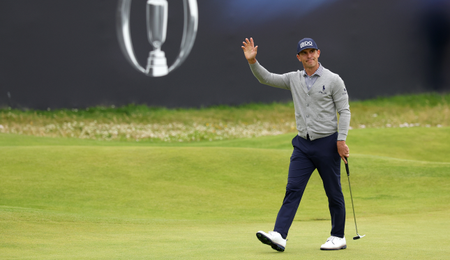 Billy Horschel waves to the crowd as he walks up the 18th fairway