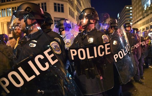 Police keep back protesters outside the National Press Club in Washington, D.C.