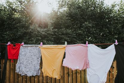 Clothes drying on a washing line outside on a sunny day.