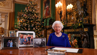 A picture released on December 24, 2019 shows Britain's Queen Elizabeth II posing for a photograph after she recorded her annual Christmas Day message, in Windsor Castle, west of London