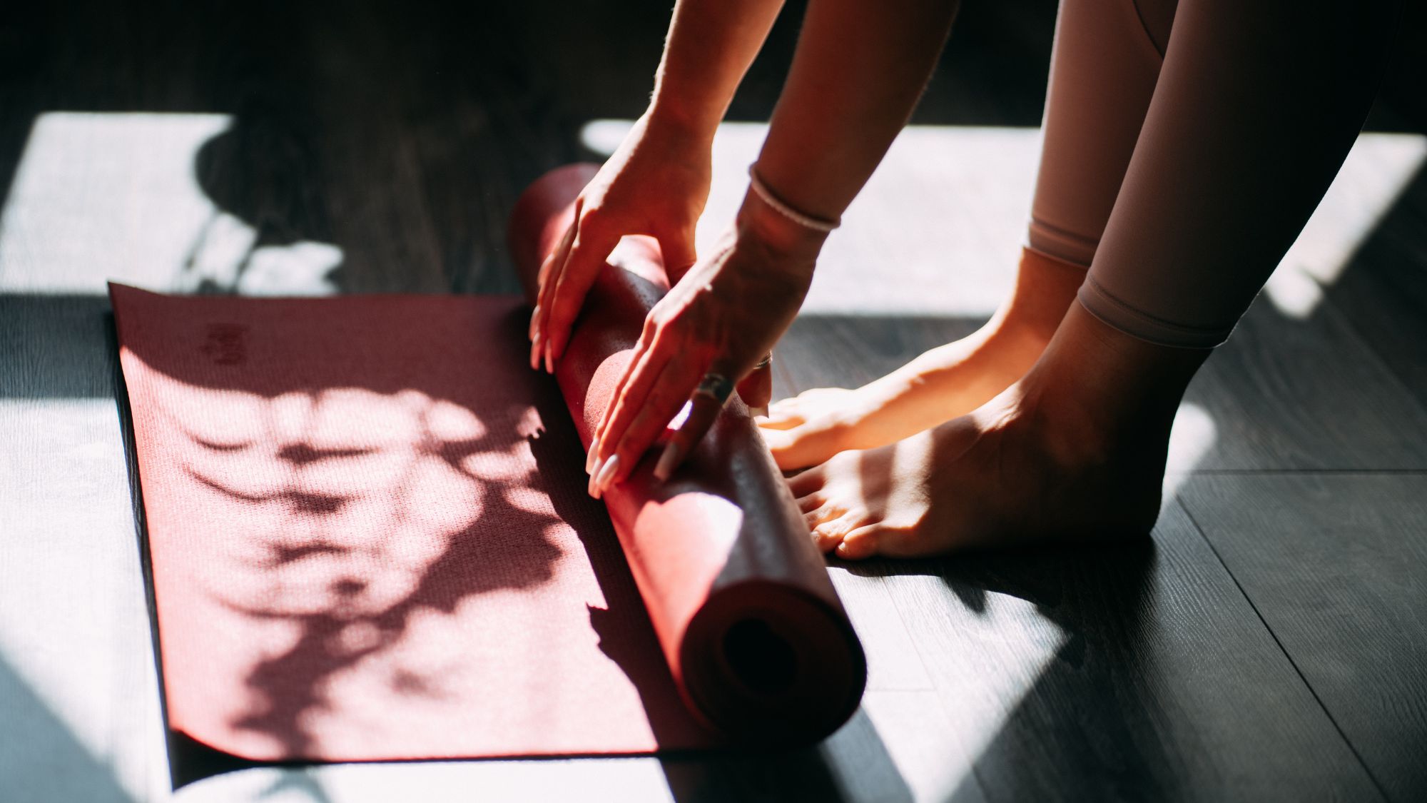 Flow state: A woman rolling up a yoga mat
