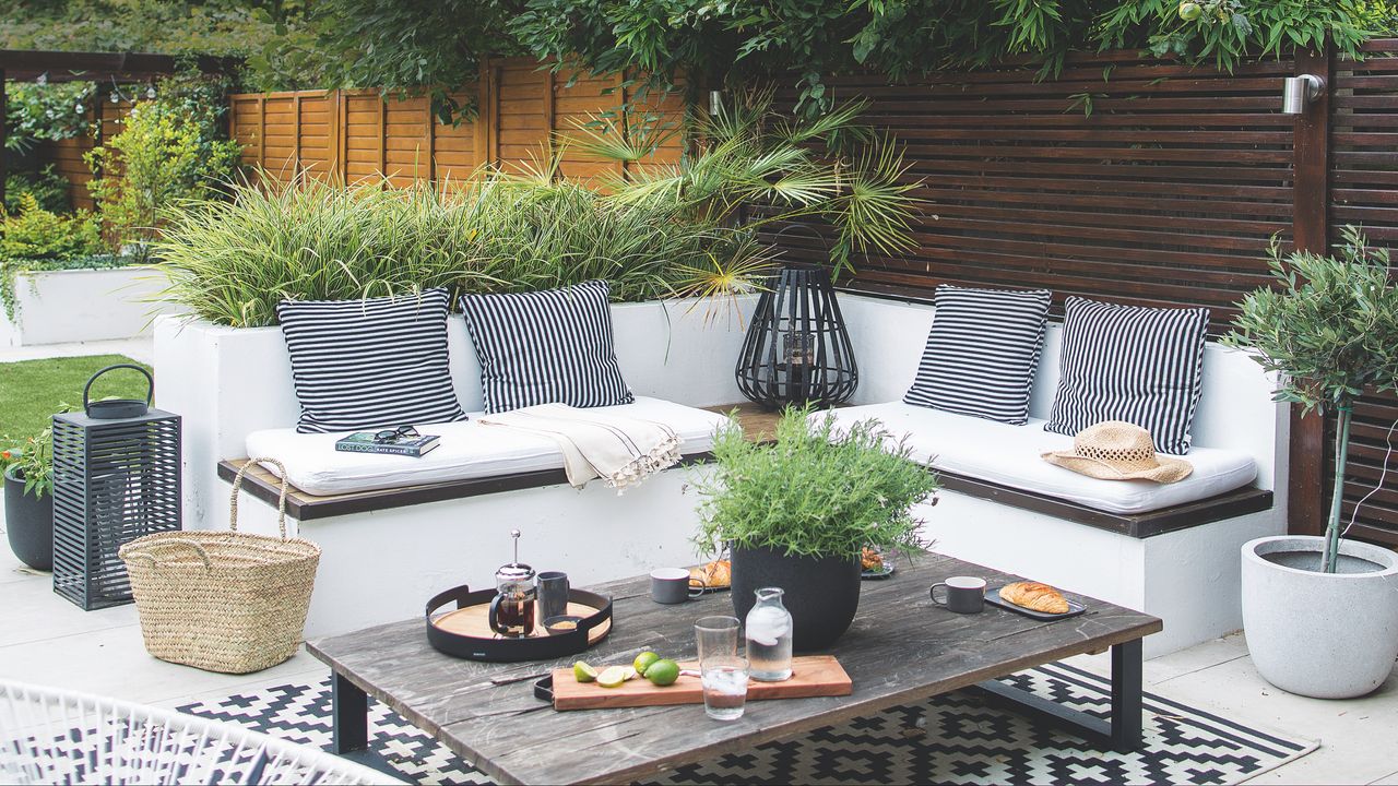 outdoor living room with bench seating and coffee table in the garden