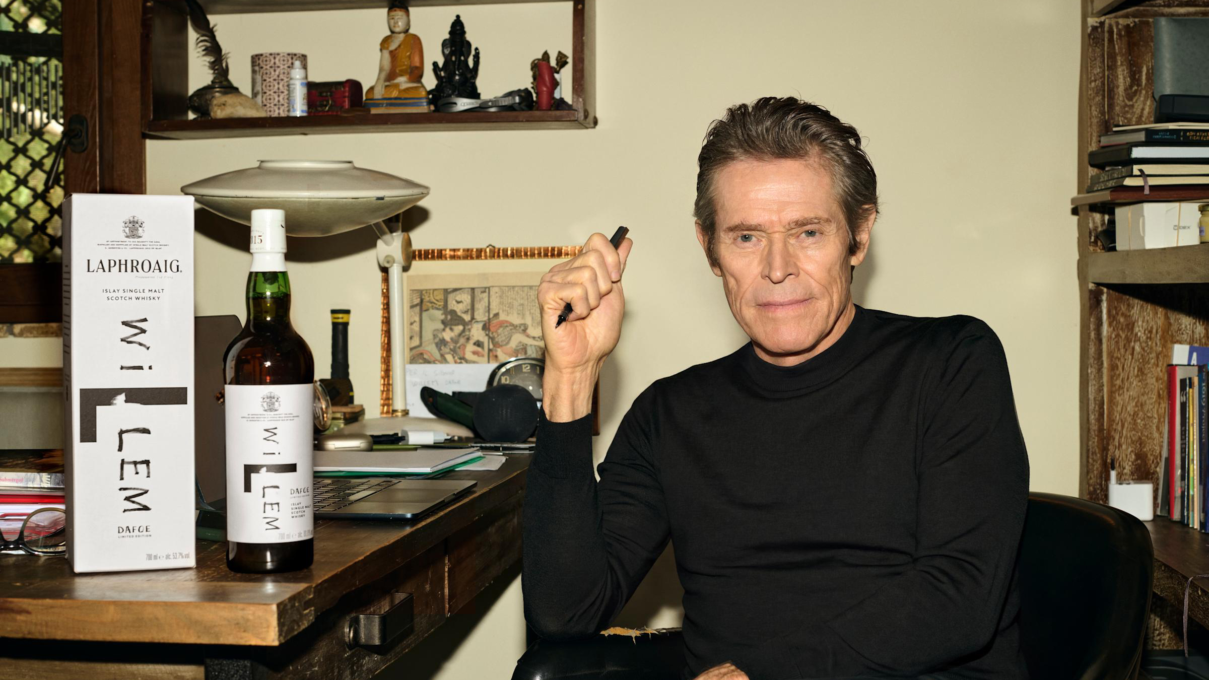 Willem Dafoe with a limited edition bottle of Laphroaig.