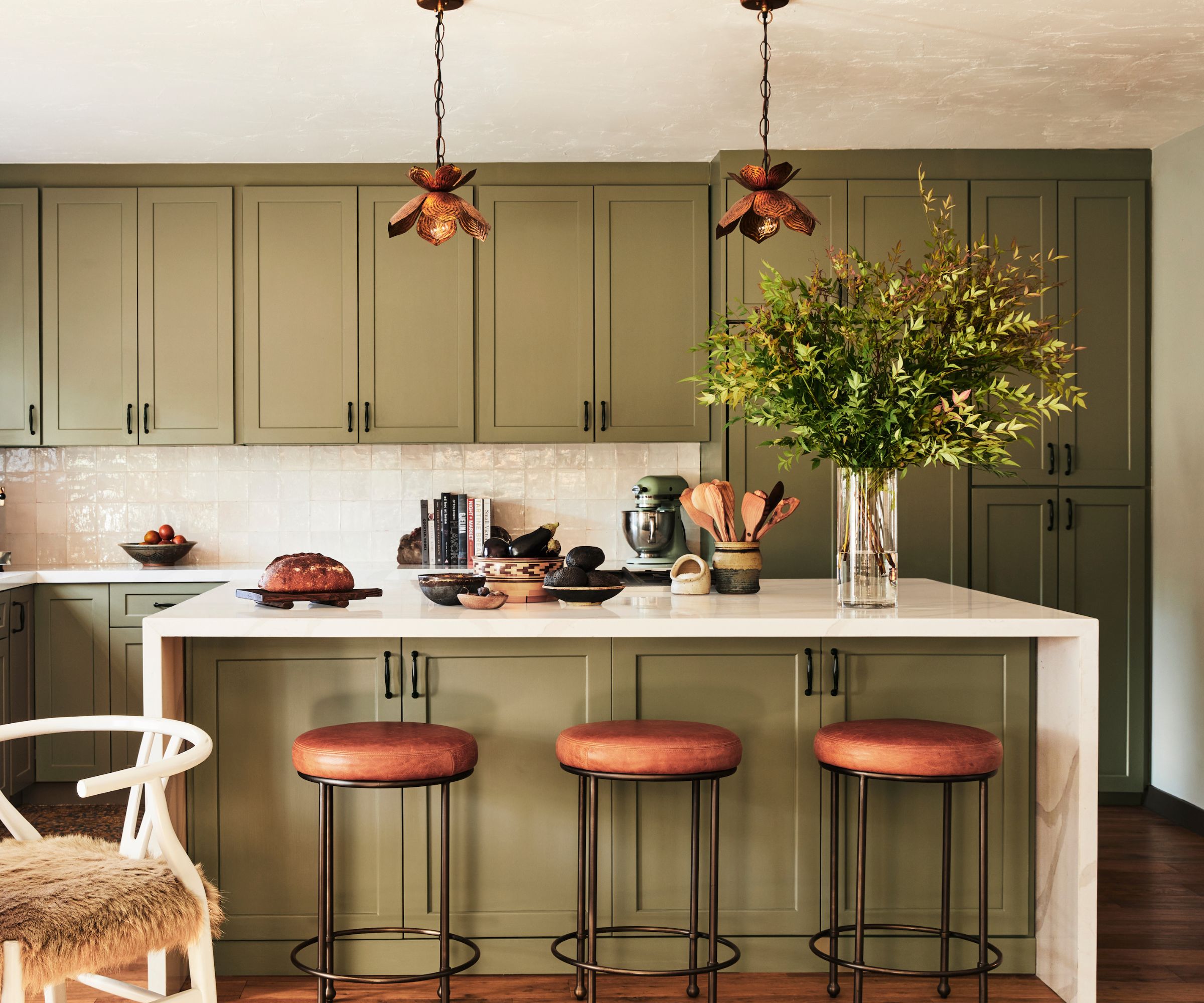 Olive green kitchen cabinets with wood details