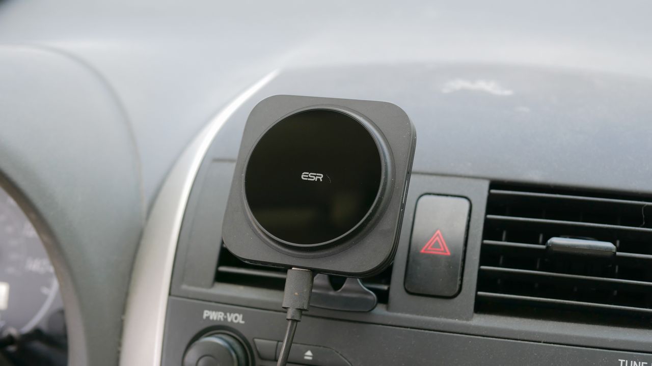 ESR HaloLock MagSafe Car Charger attached to vent clip in car with iPhone.