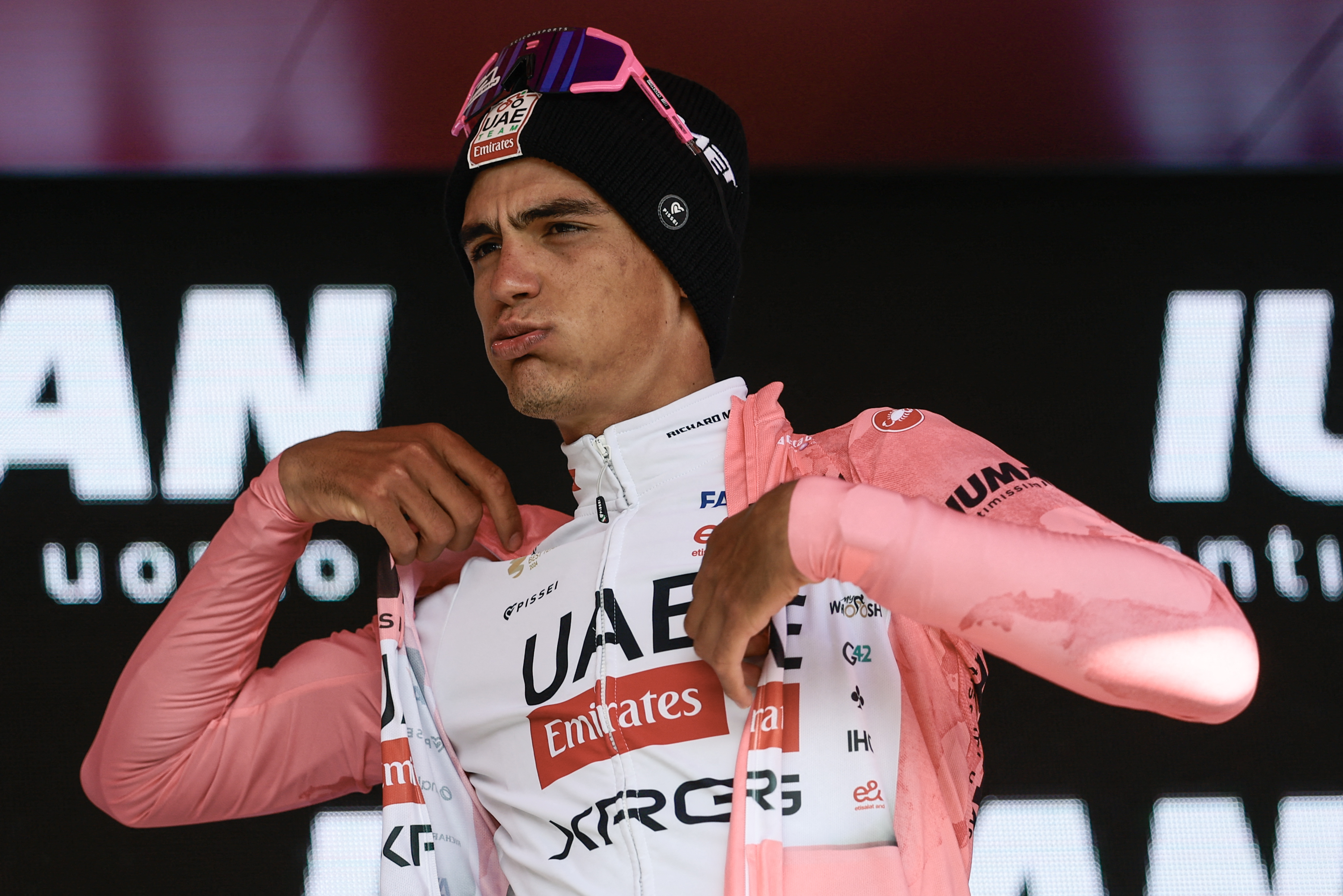UAE Team Emirates XRG's Mexican rider Isaac Del Toro puts on the pink jersey of overall leader (Maglia Rosa) on the podium after the 16th stage of the 108th Giro d'Italia cycling race of 203kms from Piazzola sul Brenta to San Valentino on May 27, 2025. (Photo by Luca Bettini / AFP) (Photo by LUCA BETTINI/AFP via Getty Images)