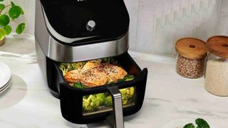 The Instant Vortex Plus 6-in-1 Air Fryer with ClearCook and OdourEase being used to cook salmon