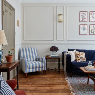 Blue striped chair in living room against a panelled wall