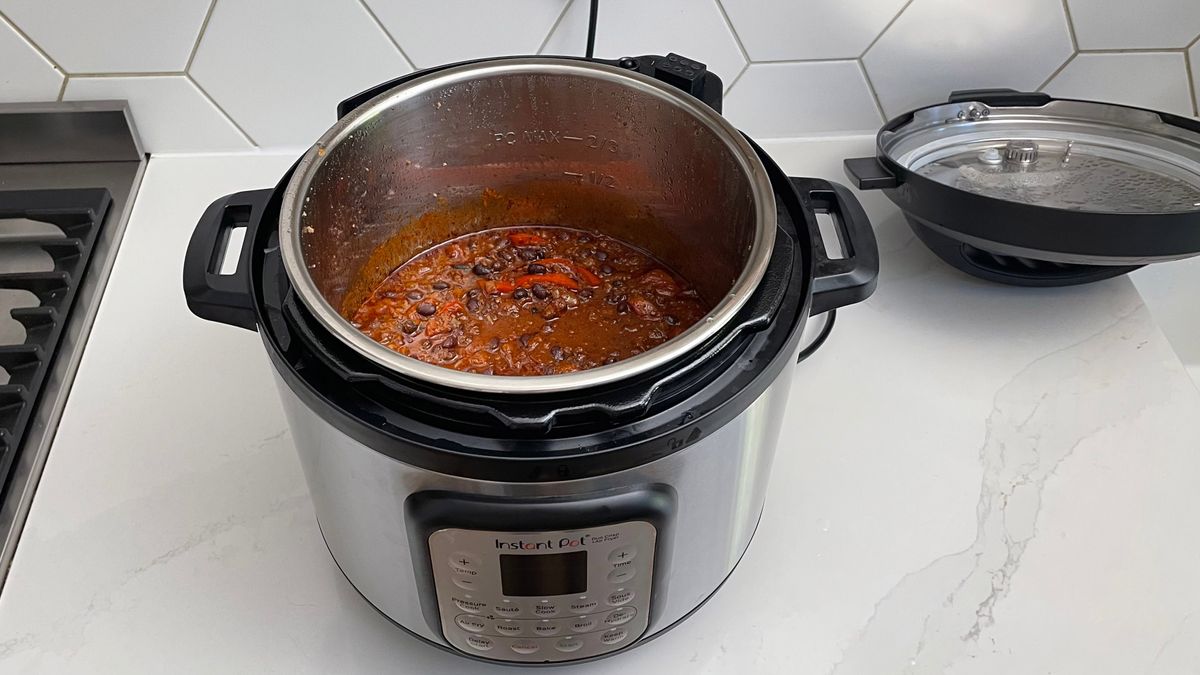 Instant Pot Duo Crisp &amp; Air Fryer on a kitchen countertop being used to cook a chilli