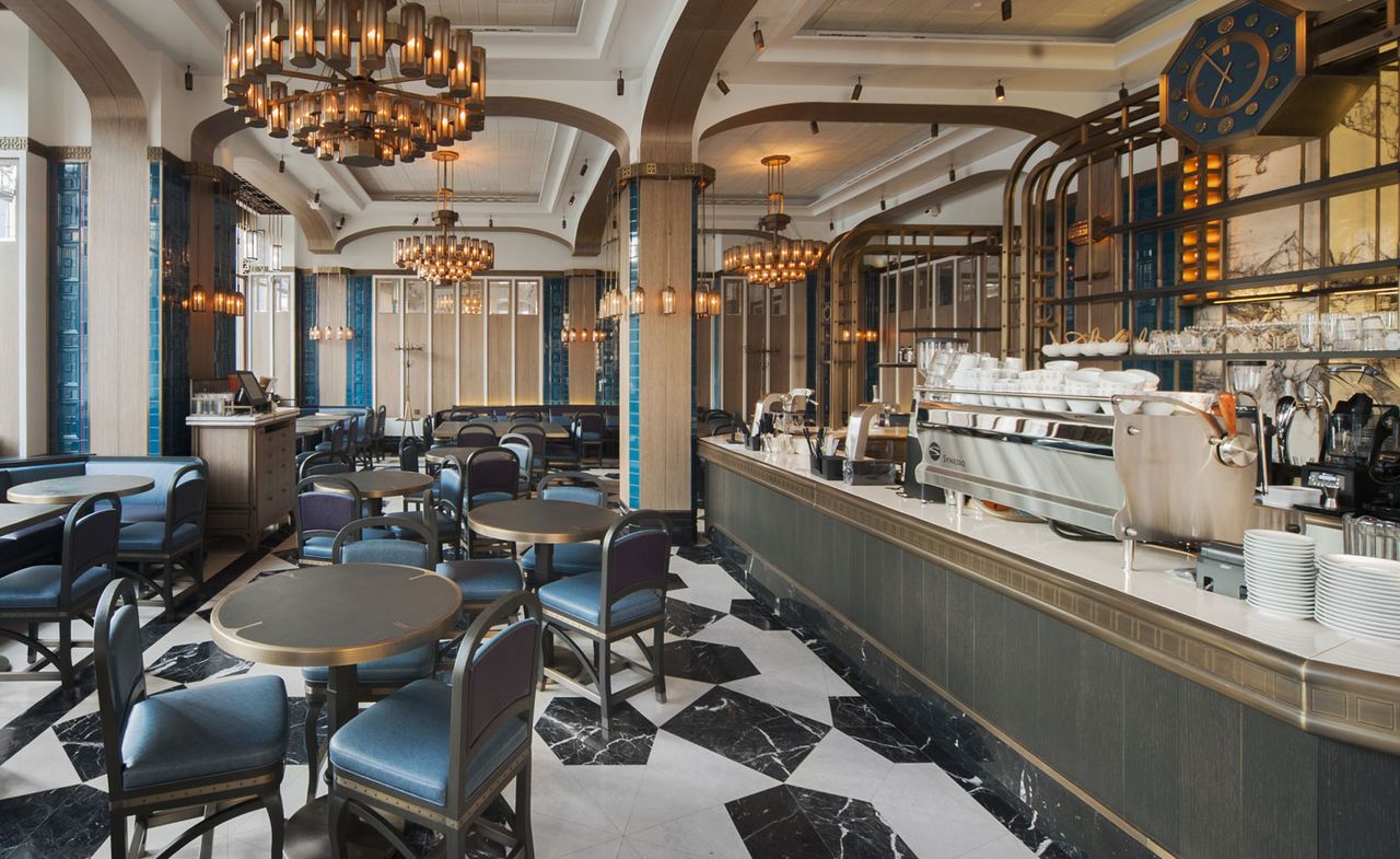 Interior of Coffeemania restaurant in Moscow with black and white floors, black table and chairs and bronze lighting