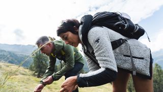 A man and a woman foraging