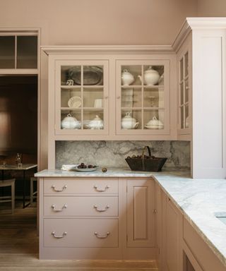 pink english kitchen with glass fronted upper cabinets