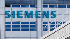 Logo and branding of Siemens pictured on the side of a company building in Berlin, Germany.