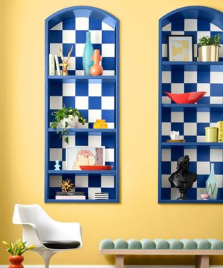 yellow walls with bright blue built-in shelving with tiled background