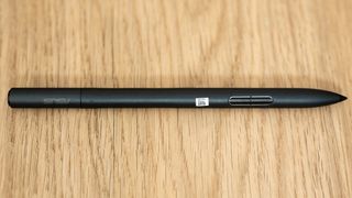 Asus ProArt P16 laptop stylus pen on a wooden surface