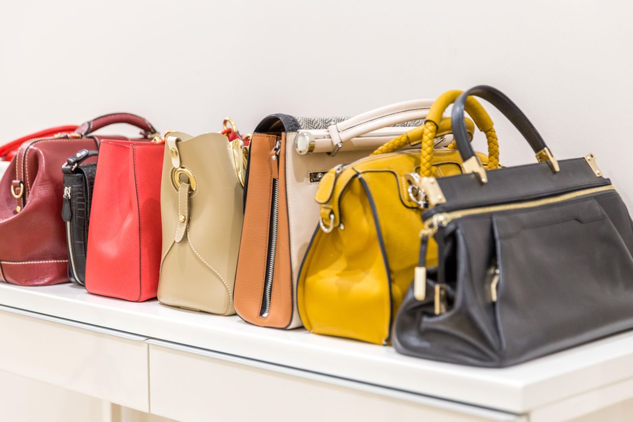 A collection of handbags arranged on a shelf