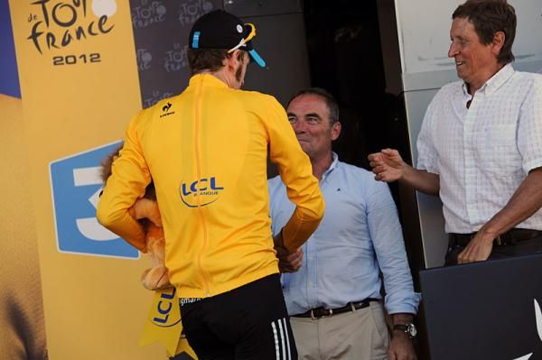 Tour de France leader Bradley Wiggins shakes hands with Bernard Hinault after stepping off the podium.