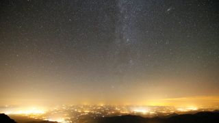 light pollution from a large city can be seen in the night sky