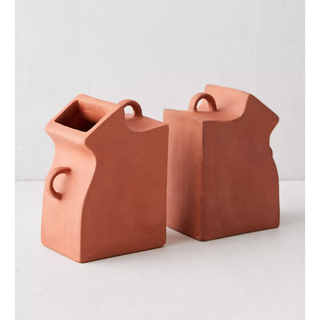 two bookends in the shape of terracotta vases