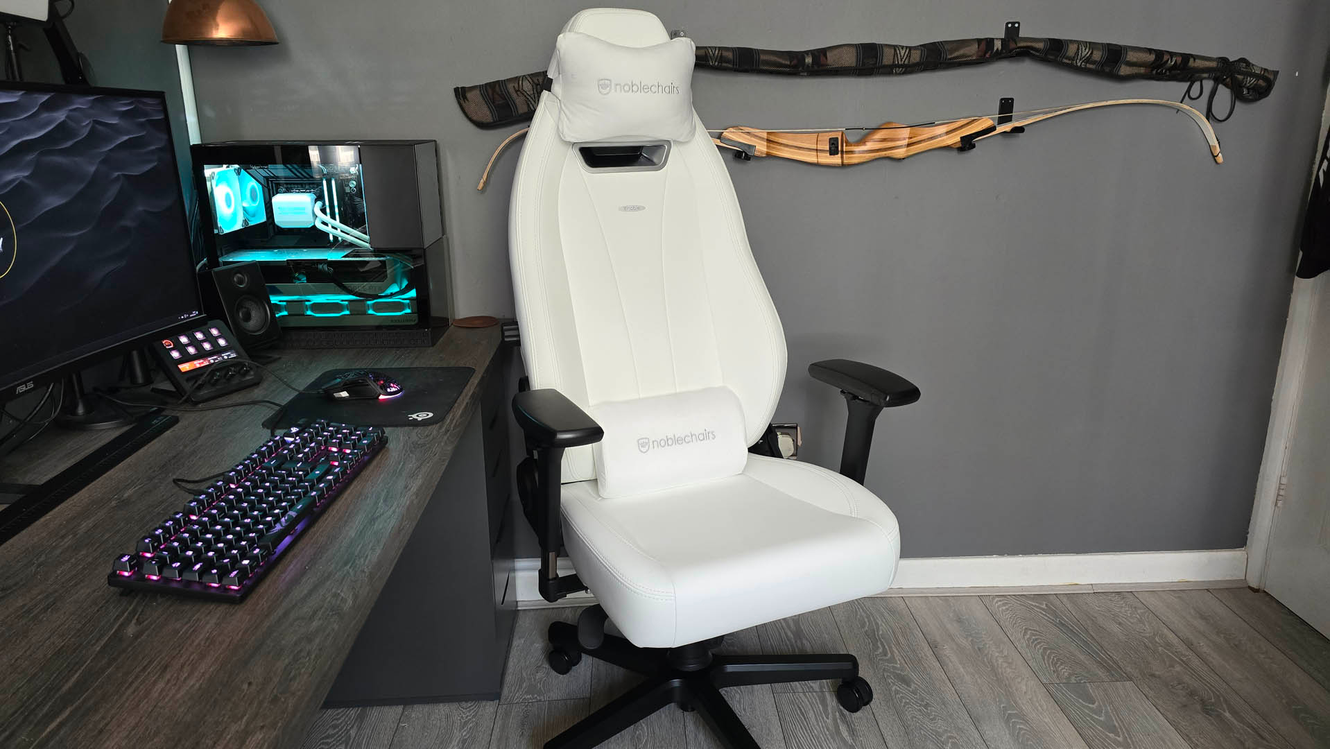The Noblechairs Legend gaming chair on a wooden floor in front of a grey wall