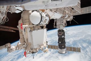 Russia's Rassvet mini-research module is seen during its installation to the International Space Station in May 2010. The airlock attached to the module (at top) is set to be moved to the Nauka multipurpose laboratory module 13 years later.