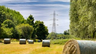 Electricity pylons and hay rolls in a field outside Radley, just after harvesting