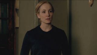 Joanne Froggatt stands dressed in black in a downstairs room in Downton Abbey.