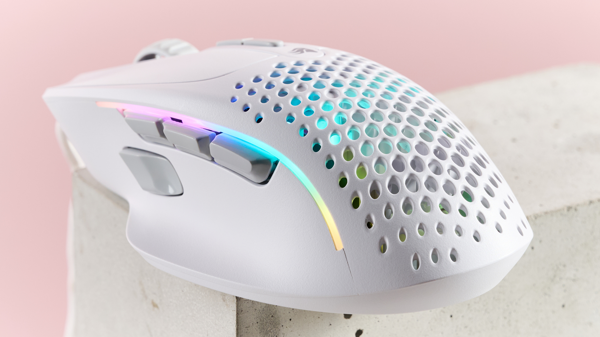 Back three-quarter view of Glorious Model I 2 with RGB lighting, on plinth with pink background