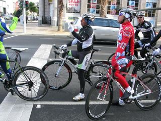 Former world champion Paolo Bettini talks to Luca Paolini (Aqua & Sapone) while stopped at lights in Geelong.
