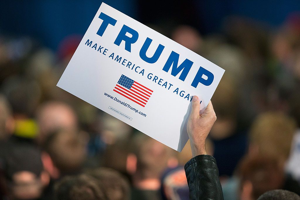 A Trump supporter holds up a placard during a campaign event