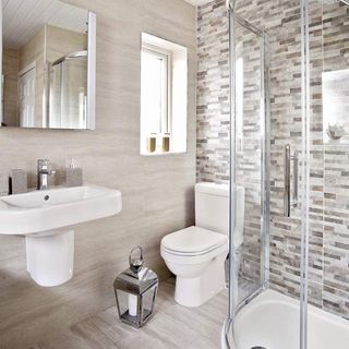 bathroom with mirror and cream tiles