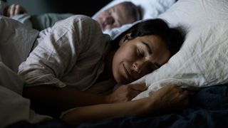 A couple falling asleep in bed