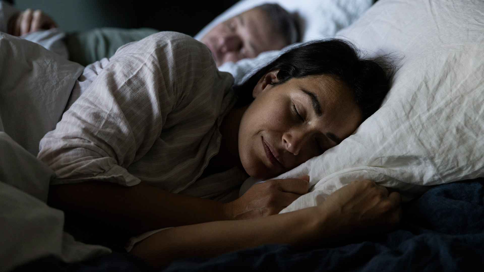 A couple falling asleep in bed