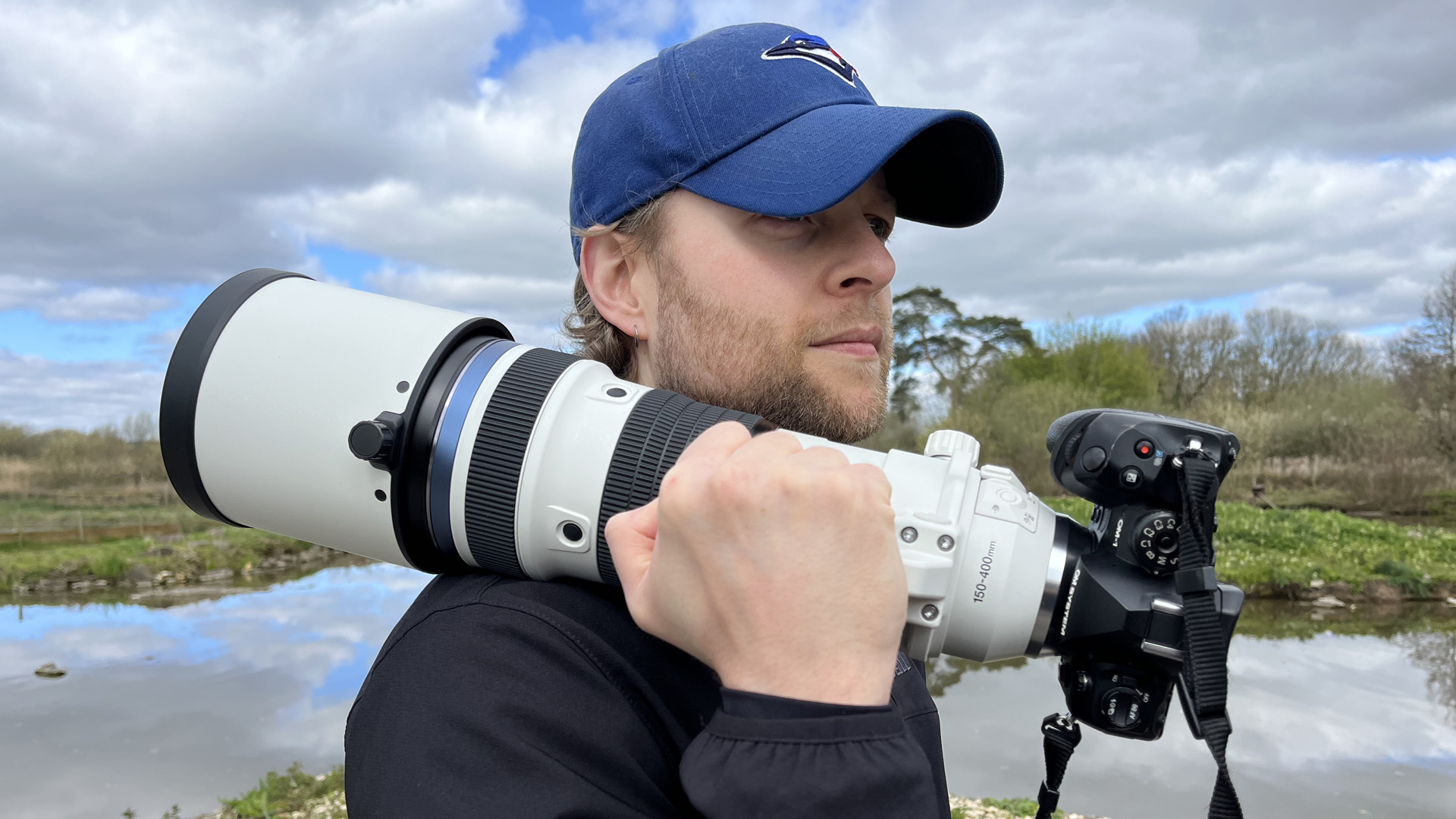 Mike Harris holding OM System M.Zuiko 150-400mm f/4.5 TC1.25x IS PRO at Slimbridge Wetland Centre