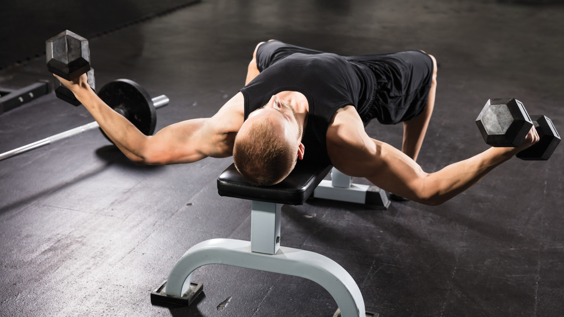 A man performing dumbbell flyes