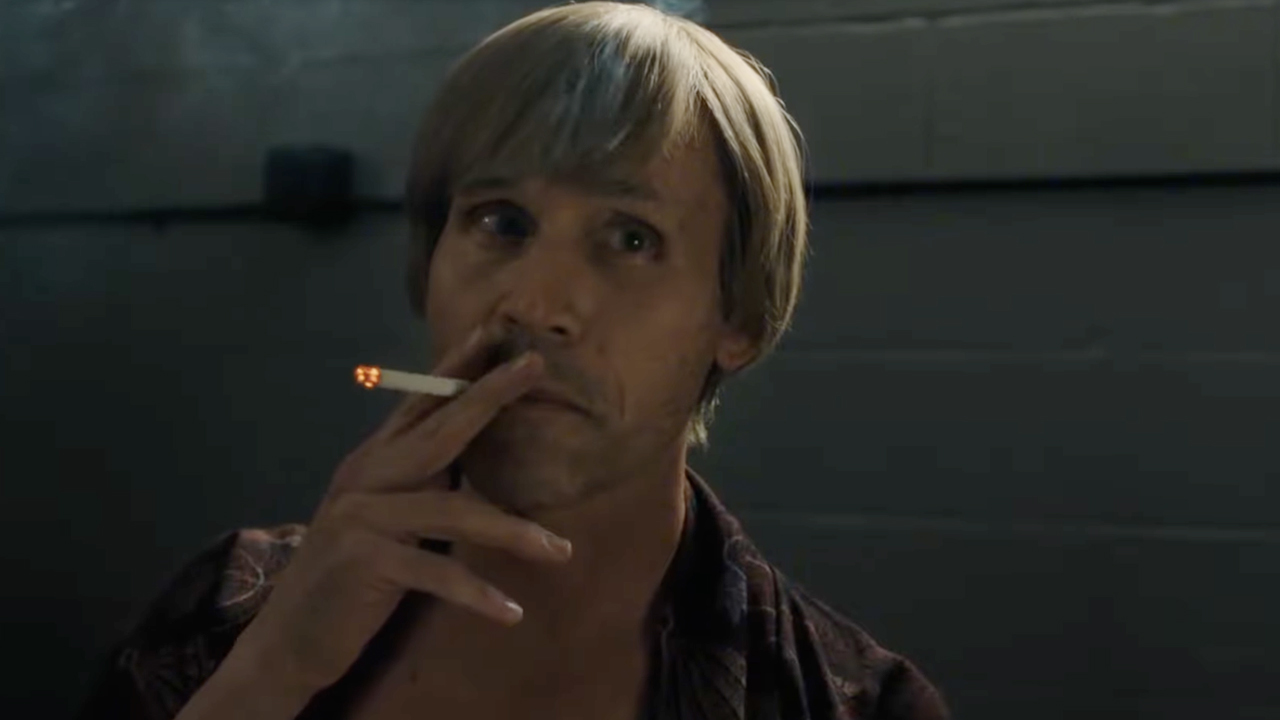 Tobias Jelinek smoking a cigarette as Richard Speck in the limited series Monster: The Ed Gein Story.
