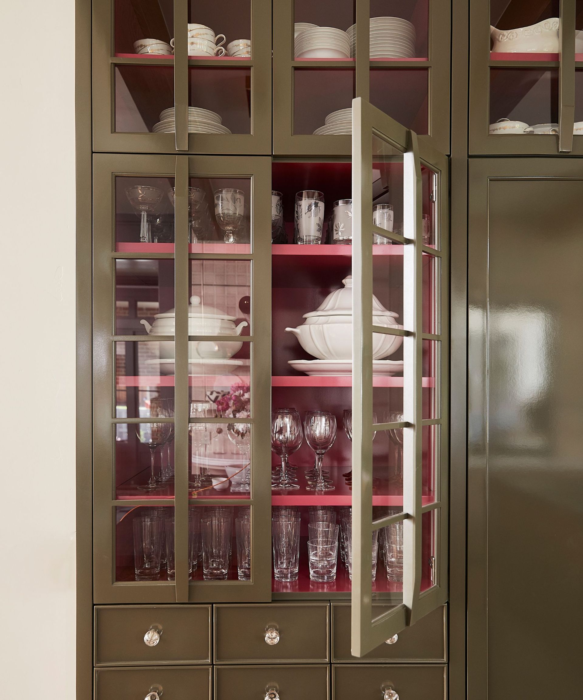 khaki kitchen cabinets with pink cupboard inners