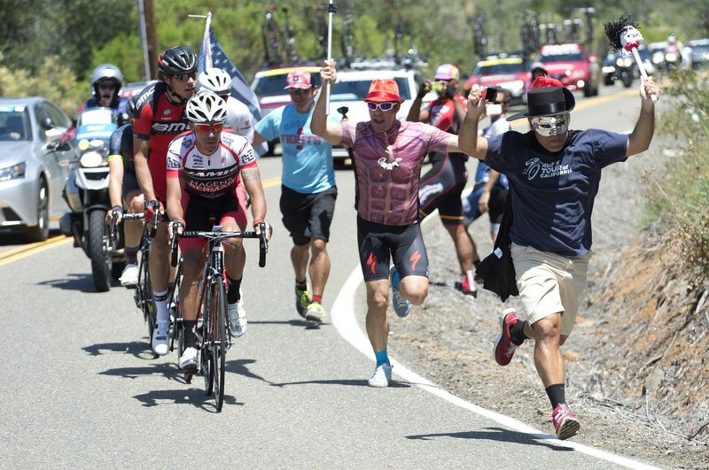 Some American fans cheer and run alongside the breakaway on the road to Lodi