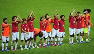 Japan players applaud their fans after defeat to the United States in the women's football final at the 2012 Olympics in London.