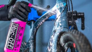 A close up of Muc-off cleaner being sprayed onto a Pinarello road bike