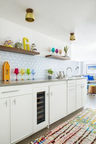 A white backsplash with bright blue tile grout