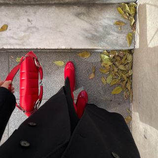 Anna Laplaca wearing red Steve Madden flats with matching tights and a Gucci Horsebit bag.